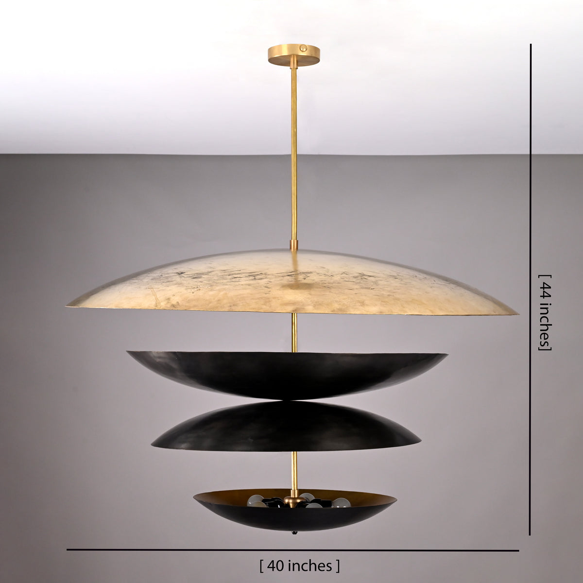 Extra-large tiered chandelier with black and gold discs, 40 inches wide and 44 inches tall, suspended by a brass rod against a neutral grey background