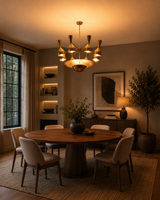 Venice Bottle Disc Chandelier styled above dining table in a warm modern room with soft ambient lighting.