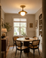 Verona brass dome globe flush mount installed above a dining table in a warm modern dining room, Model 33162.