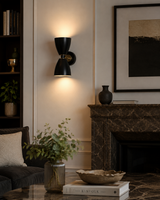 Verona 2 light double cone wall sconce in matte black with brass accents installed in a modern living room