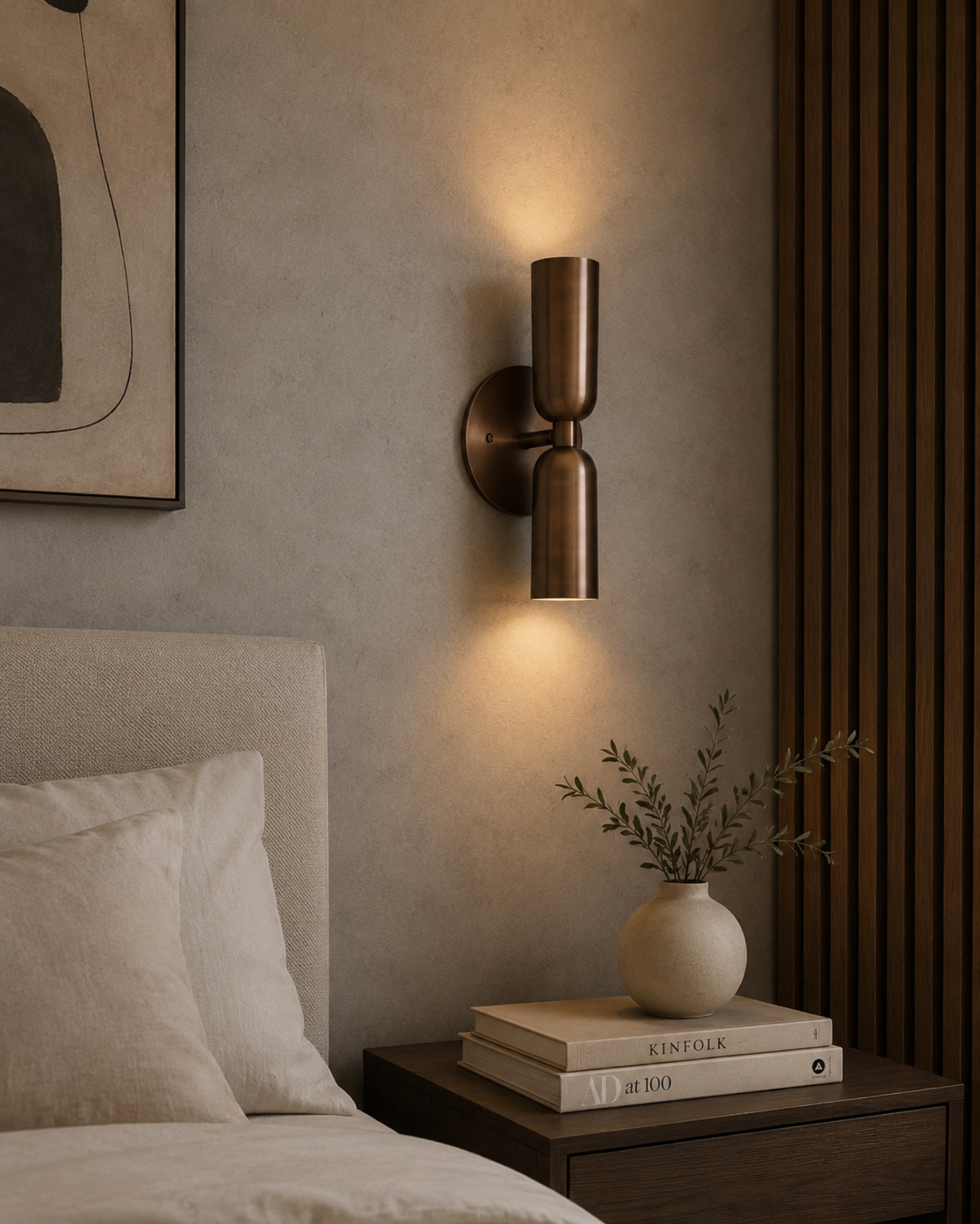 erona double cylinder wall sconce installed beside a bed with warm up and down lighting in a modern bedroom, Model 32833.