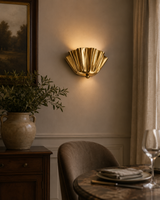 Verona Fluted Flower Wall Light installed in a contemporary dining room, casting warm ambient illumination and creating an elegant decorative accent on the wall.
