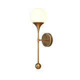 Side view of Verona globe wall sconce showing slim brass stem, round wall canopy and frosted glass globe shade.