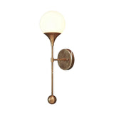 Side profile of the Verona Globe Glass Wall Sconce displaying its slim brass arm, decorative finial, and opal glass globe.