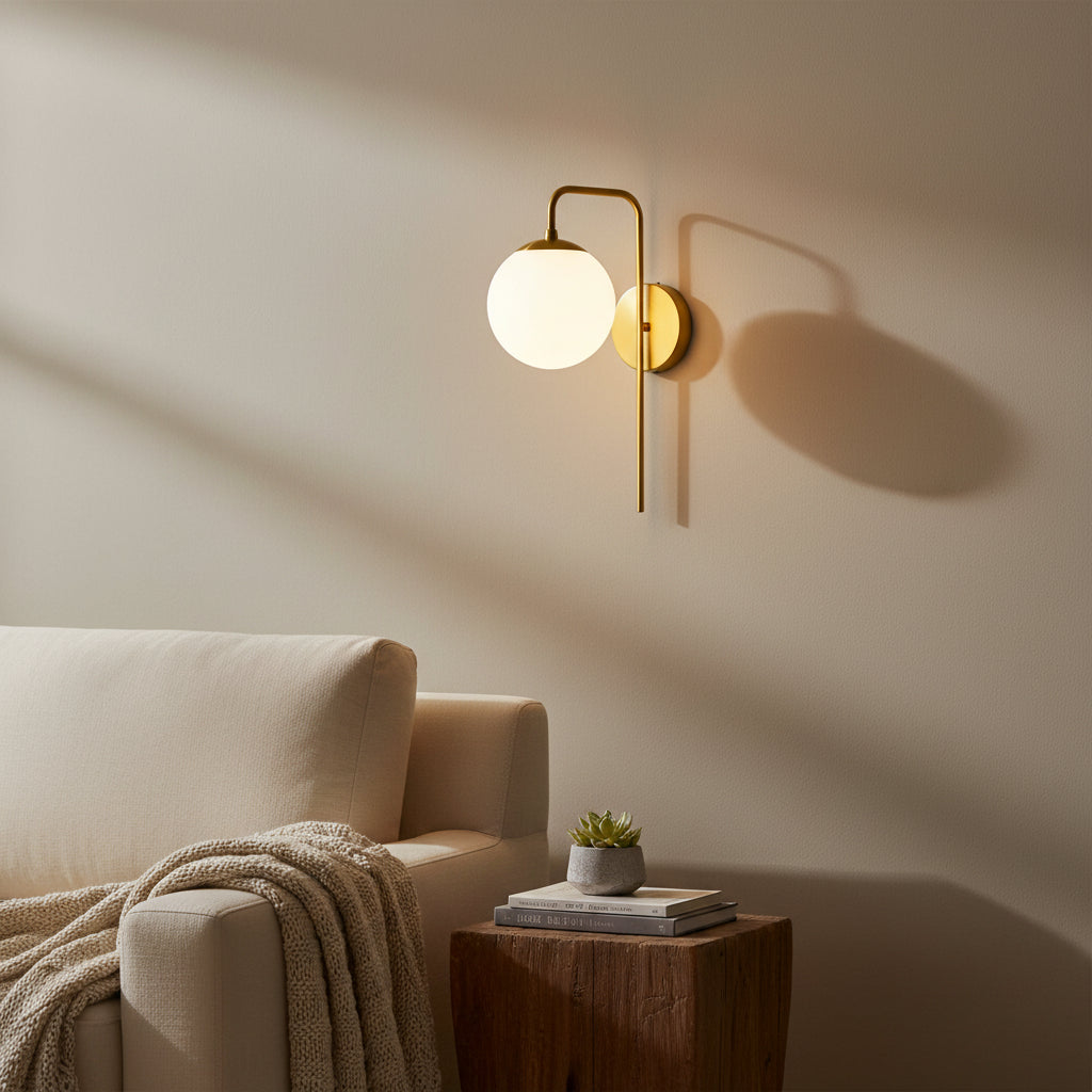 Verona brass globe wall sconce with curved arm and opal glass shade, front view – Model 32808