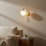 Verona brass globe wall sconce with curved arm and opal glass shade, front view – Model 32808
