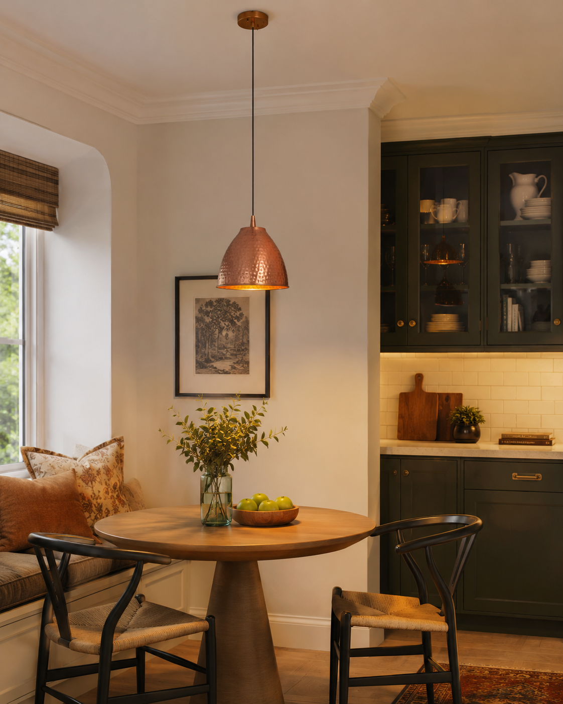 Verona hammered copper bell pendant light installed above a round dining table in a modern farmhouse dining room, providing warm ambient illumination with its handcrafted hammered copper finish.