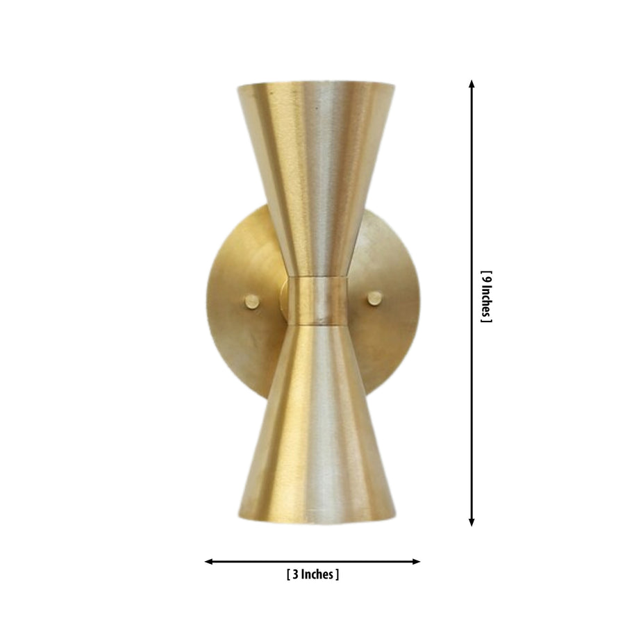 Verona hourglass globe wall sconce installed in a contemporary living room, providing warm ambient lighting above a wooden console in a modern interior.