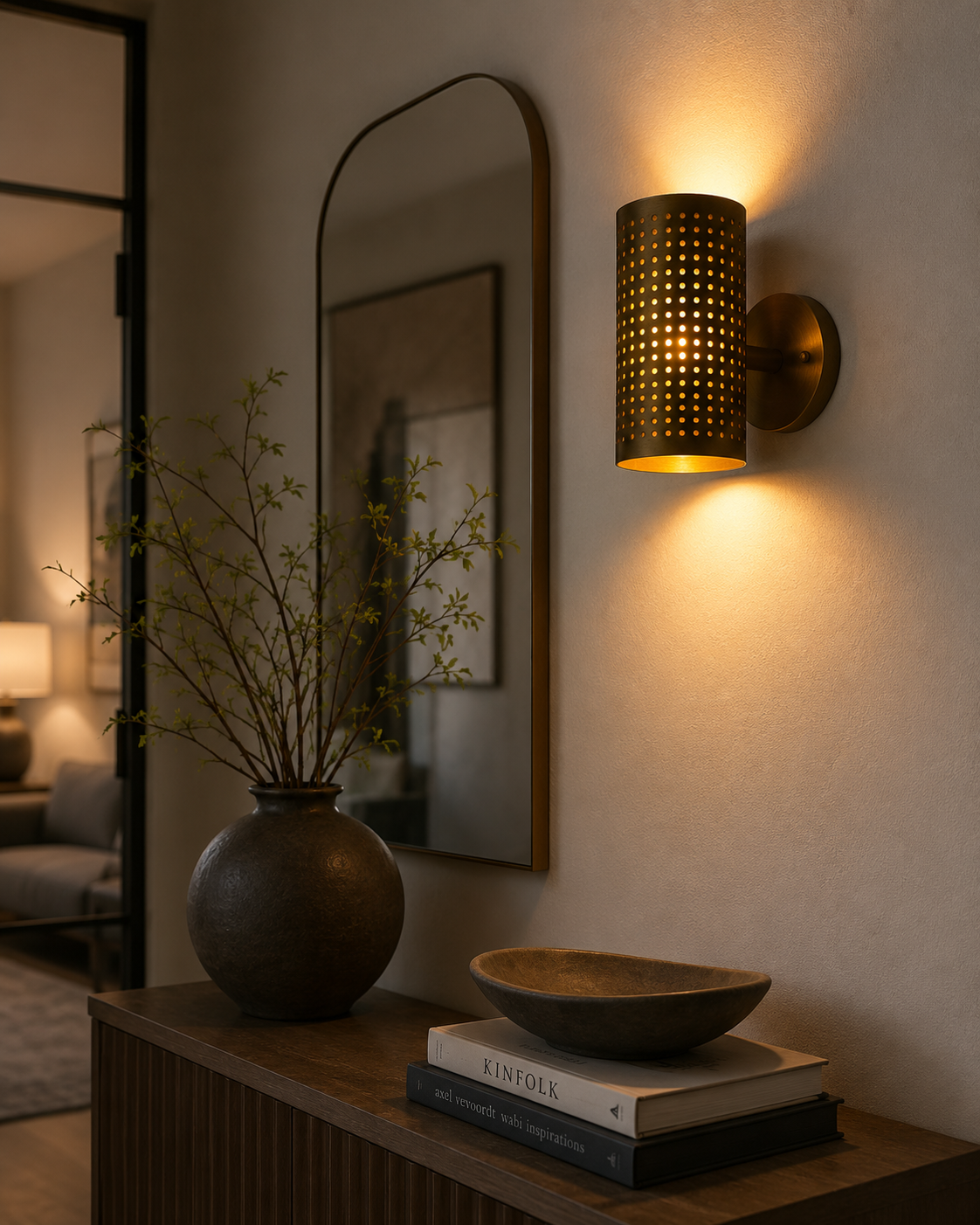 Verona perforated cylinder wall sconce installed in a modern interior with warm decorative up and down lighting, Model 32783.