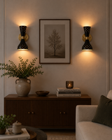 Pair of Verona perforated double cone wall sconces installed in a living room with warm up and down lighting.