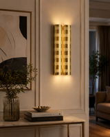 Verona 14 inch perforated double cylinder brass wall sconce illuminated in an elegant contemporary interior