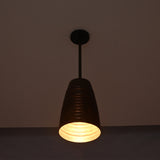 Close-up night view of the Verona ribbed bell pendant light highlighting its warm downward glow and handcrafted ribbed copper shade.