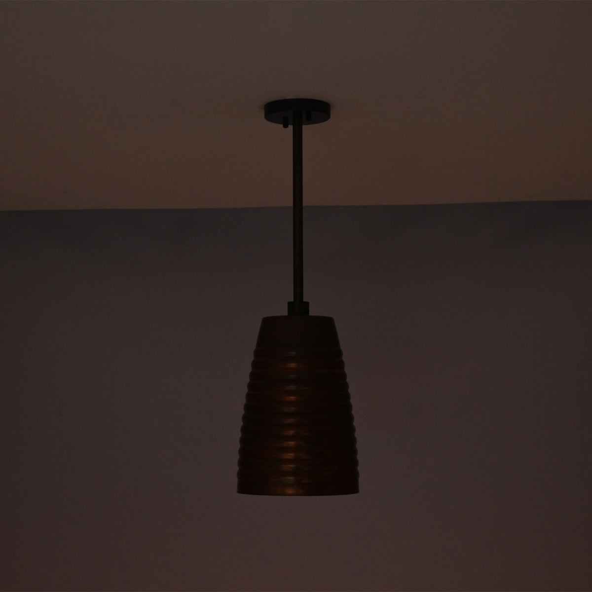 Unlit night view of the Verona ribbed bell pendant light featuring a handcrafted ribbed copper shade with adjustable down rod suspension.