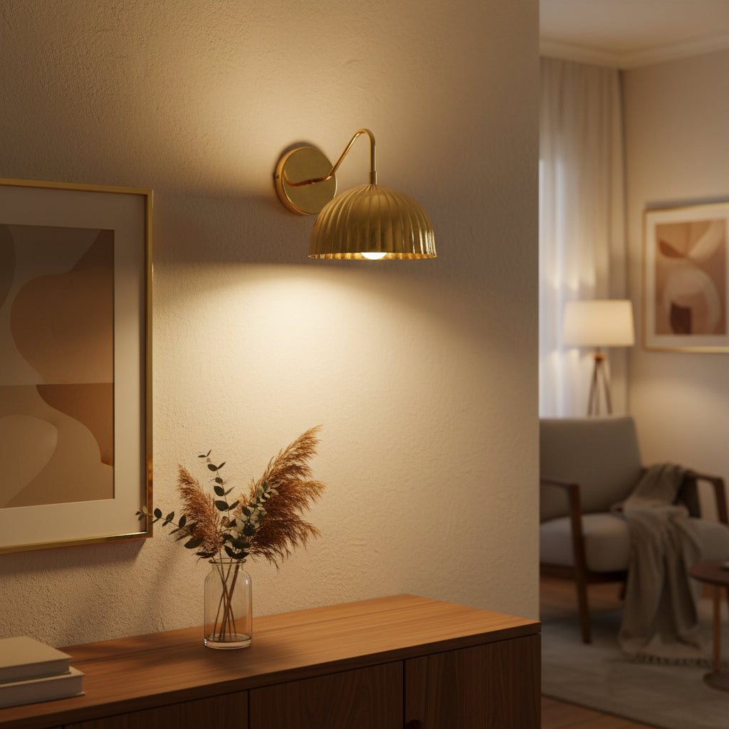 Angled view of Verona 1-light wall sconce featuring a polished brass ribbed dome shade and curved arm.