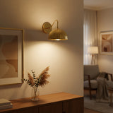 Angled view of Verona 1-light wall sconce featuring a polished brass ribbed dome shade and curved arm.