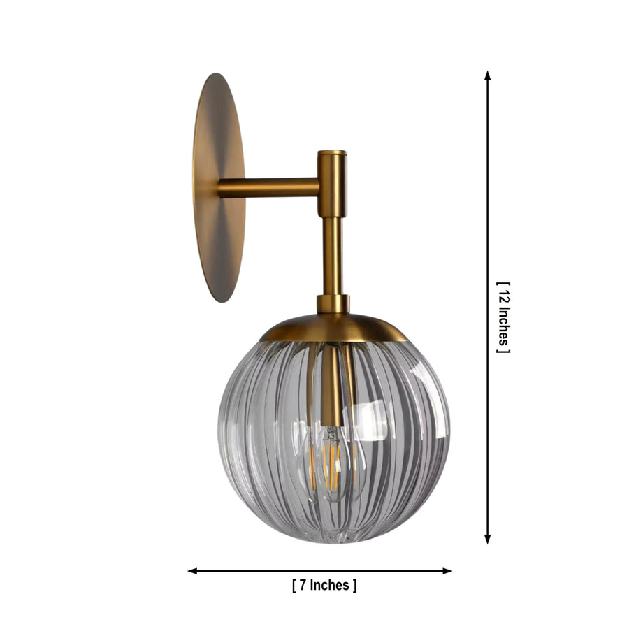Verona ribbed glass globe wall sconce with brass finish styled beside a bed in a modern bedroom – Model 32778