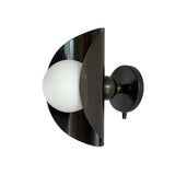 Angled view of Verona sculptural wall sconce featuring an opal globe and curved shield design, Model 32790.