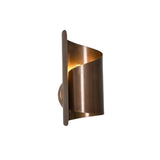 Verona sculptural wrap wall sconce illuminated with warm ambient light through curved metal shade