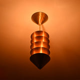 Verona Stacked Cone Pendant close ceiling view showing layered cone shades and dramatic warm lighting.