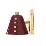 Side profile of the Verona Studded Cone Wall Sconce highlighting the handcrafted burgundy cone shade, decorative brass studs, and rectangular brass wall mount.