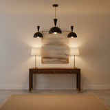 Verona 3 light black dome chandelier with brass arms and exposed bulbs displayed on a clean white background.