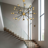 Versailles 36 light Mid-Century Modern Sputnik chandelier shown from a perspective view with black arms and brass-tone bulb holders.