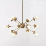 Angled view of the Versailles 12 light brass-tone Sputnik chandelier with multidirectional arms and clear glass globes.