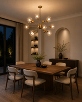 Versailles 12 light brass Sputnik globe chandelier displayed above a modern wood dining table with upholstered chairs.
