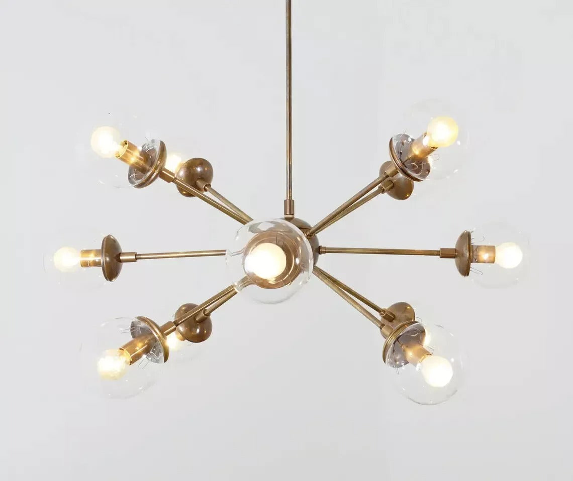 Versailles 12 light brass-tone Sputnik chandelier with clear glass globe shades shown from the front.