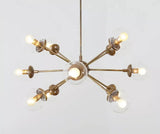 Versailles 12 light brass-tone Sputnik chandelier with clear glass globe shades shown from the front.