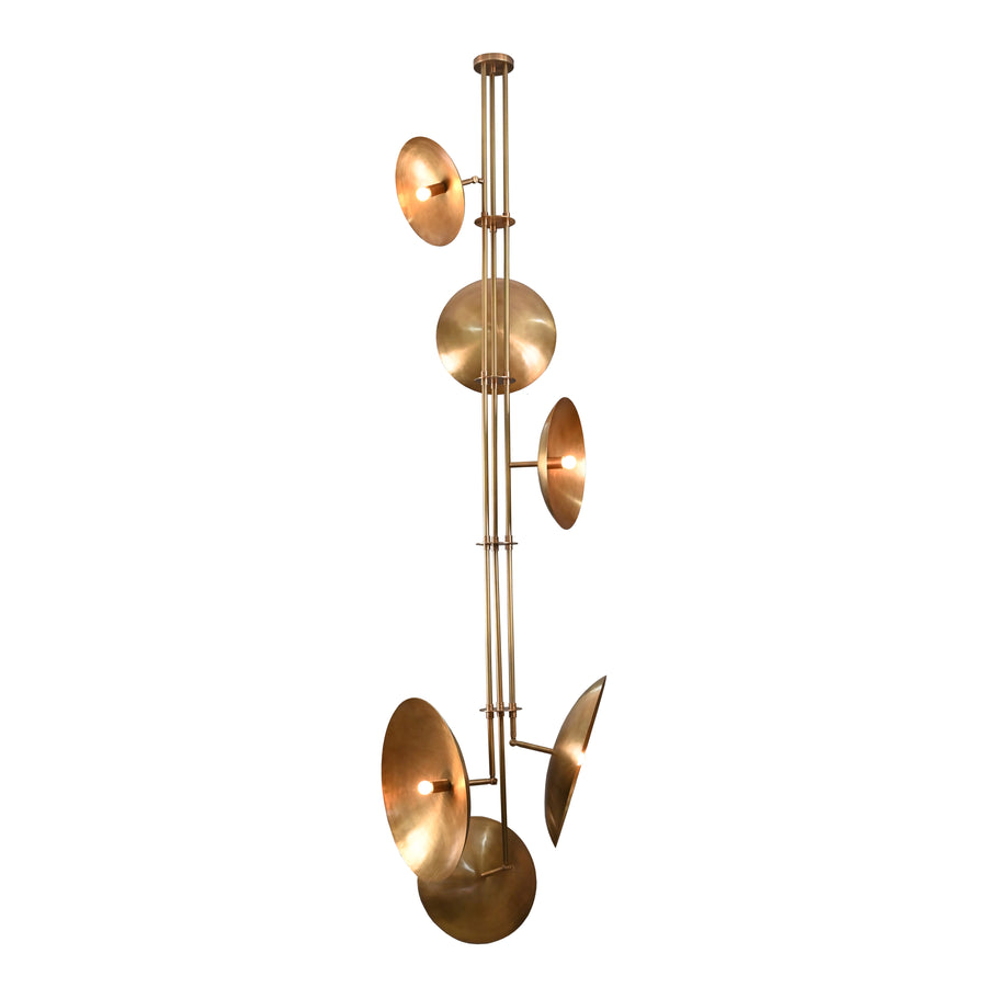 Vertical brass chandelier with six disc-shaped shades, showcasing sculptural form and warm ambient lighting.