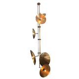 Contemporary brass disc chandelier with elongated vertical structure designed for high ceilings.