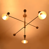 Underlit nighttime view of brass cone chandelier casting soft golden light