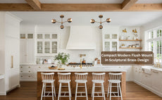 Ambient brass chandelier casting warm light on ceiling in a modern interior