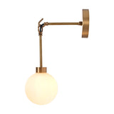 Side profile of the Windsor Modern Brass Globe Wall Sconce showcasing its decorative brass arm, hanging ring detail, frosted opal glass globe, and round wall canopy.