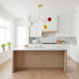 Zurich 3 light brass branch chandelier shown from an angled view with white, yellow and red globe shades.