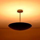 Ambient brass ceiling chandelier radiating soft warm light across the ceiling