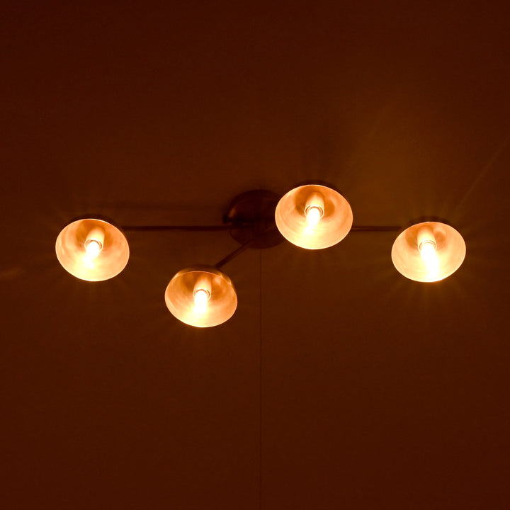 Brass patina dome chandelier glowing in warm evening light – soft, even lighting across four shades