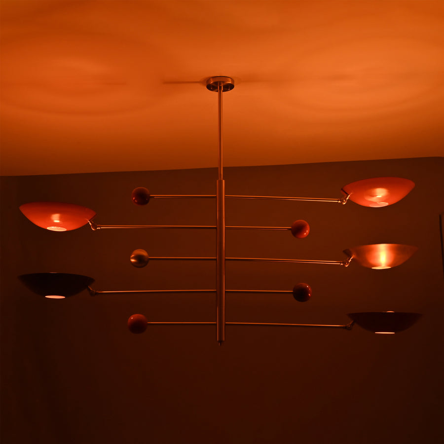 Sculptural modern chandelier with red and brass domes in balanced orbit design
