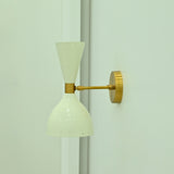 Adjustable Amsterdam wall sconce with tiltable brass construction and sculptural double cone form