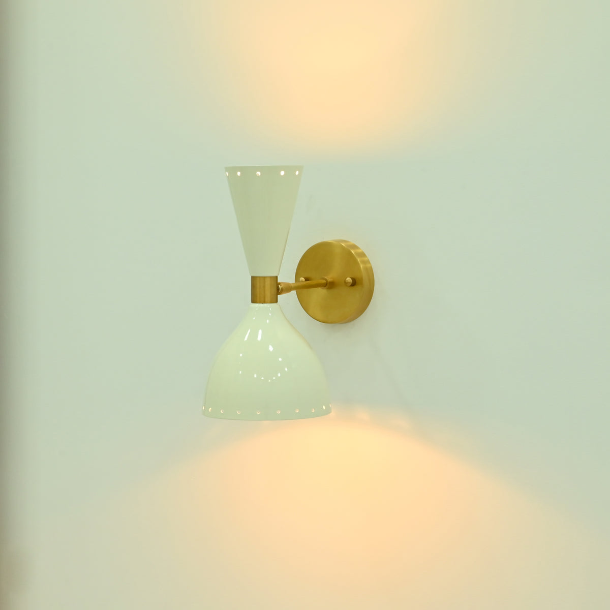 Compact 11.5 inch Amsterdam wall sconce displayed in a refined hallway with enamel shades and raw brass finish