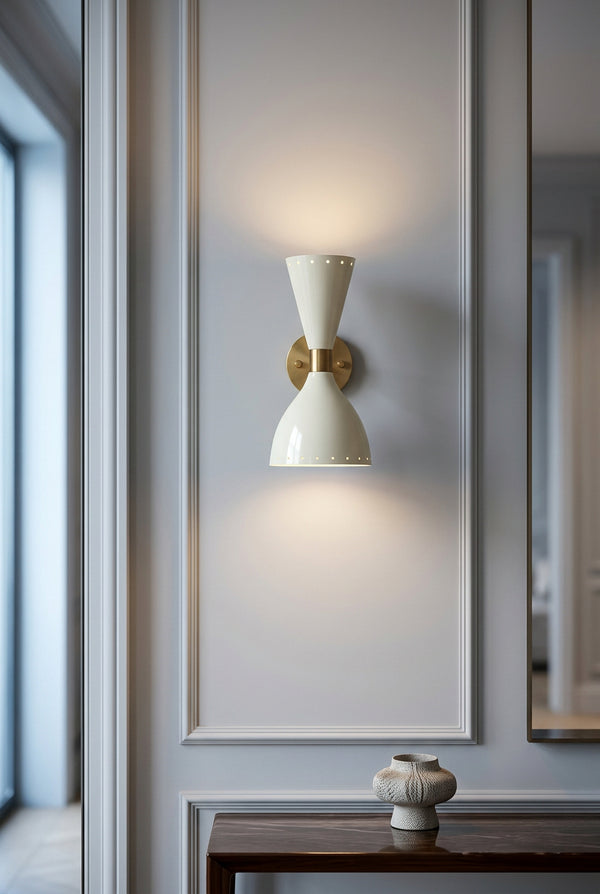 Diabolo style up and down wall light casting warm illumination above and below the fixture