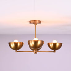 Side angle of modern brass chandelier with four bowl shades and E26 bulb sockets