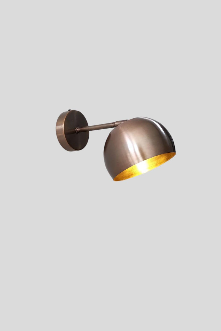 Side view of antique patina brass wall light with adjustable arm and brushed finish by Brass Leaf Studio