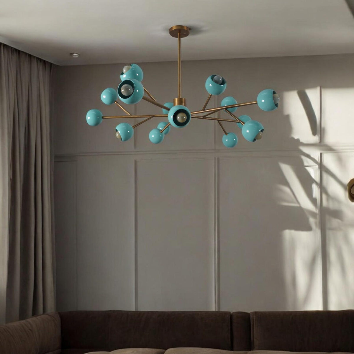 Aqua globe brass sputnik chandelier installed in a contemporary living room, casting warm modern ambient light.