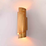 Arcus brass ribbon wall sconce shown in office interior with warm up and down ambient glow