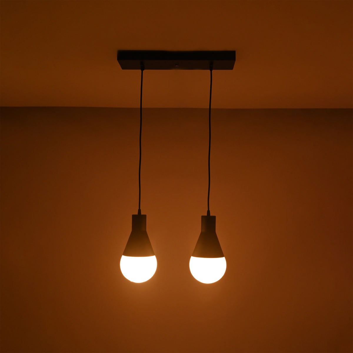Close-up illuminated view of the Aspen Dual Socket Pendant Chandelier highlighting its dual pendant configuration and warm light output.