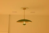 Sculptural dome ceiling light with brushed brass interior, verdigris exterior and central illuminated stem
