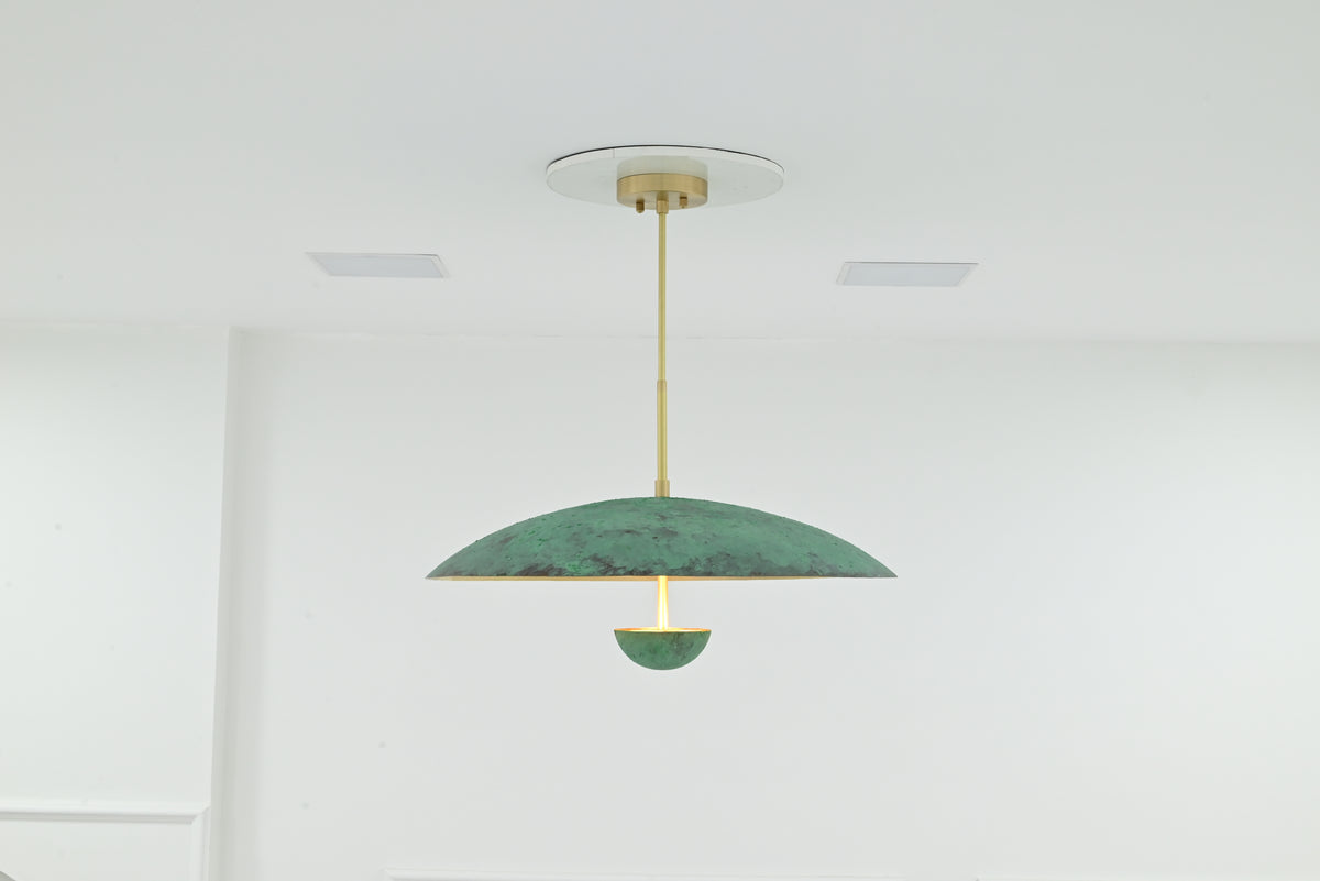 Illuminated Athens verdigris chandelier with three LED lights creating a warm ambient glow beneath the dome