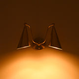 Aurelia brass wall sconce with dual tapered cone shades and decorative ball accents for modern and transitional interiors